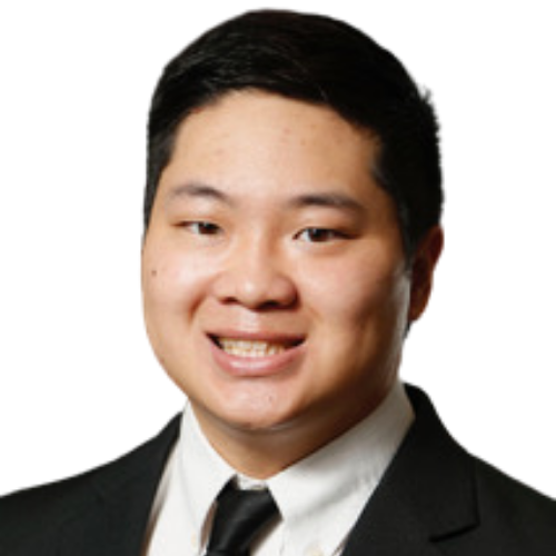 Professional headshot of a smiling Asian man in a black suit and tie, head and shoulders.